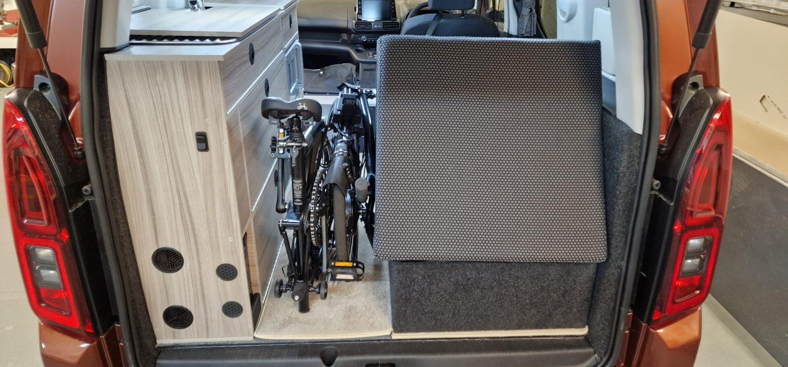 Brompton folding e-bike stored in Vikenze III-e campervan